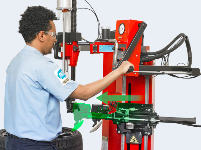 Man operating lever on Hunter TCX70 Pro tyre changer